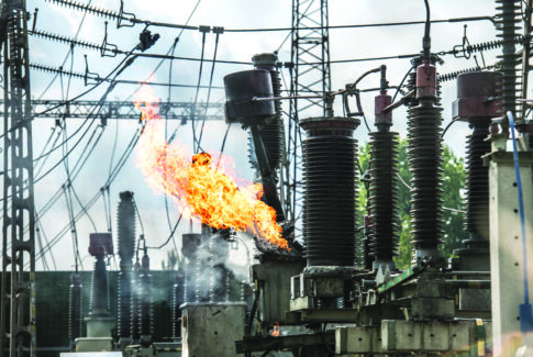 Transformer explosion in power plant. High-voltage insulator on fire. Electric explosion.
